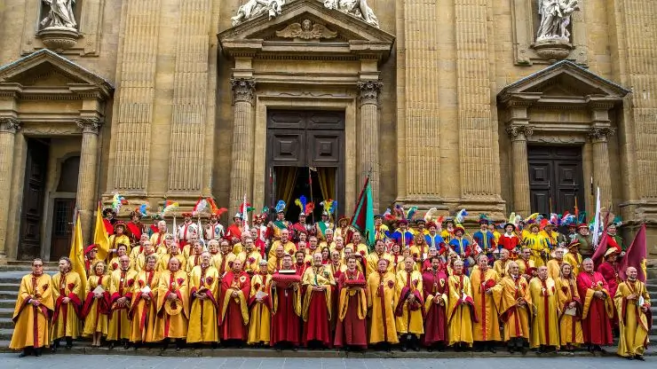 Official ceremony of the Chianti League in front of a church, with members in historic dress